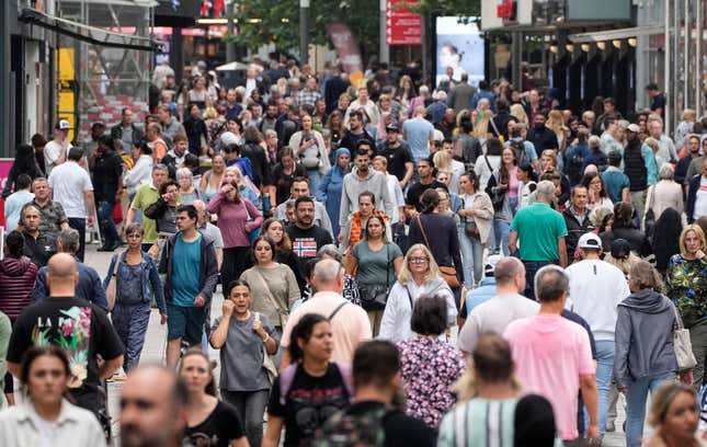 FILE - People walking the main shopping street in Dortmund, Germany, on Sept. 28, 2023. Inflation that has been plaguing Europeans made a marked decline in September, strengthening hopes that consumers will eventually get relief from costlier groceries, vacations and haircuts — and that the European Central Bank won’t have to further restrict the economy by raising interest rates from already-record highs. (AP Photo/Martin Meissner, File)