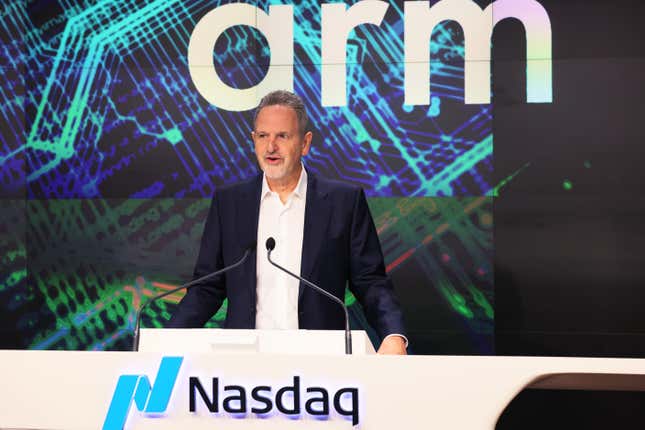 Rene Haas speaks in front of a backdrop that says Arm at a podium that says Nasdaq