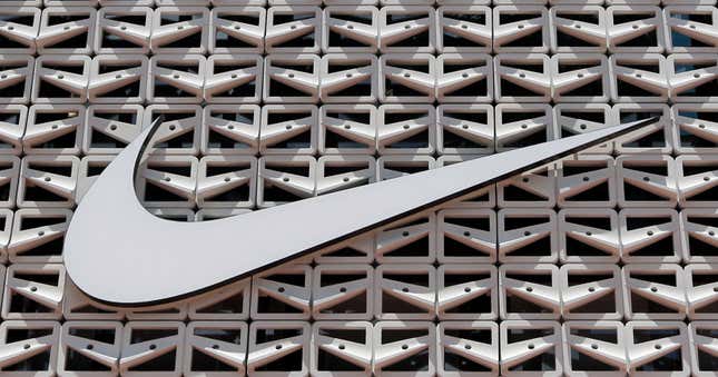 File - The Nike logo is shown on a store in Miami Beach, Fla. on Aug. 8, 2017. An agreement to weed out global tax havens and force multinational corporations, among them Apple and Nike, to pay a minimum tax has been weakened by loopholes and will raise only a fraction of the revenue that was envisioned, a tax watchdog backed by the European Union has warned. (AP Photo/Alan Diaz, File)