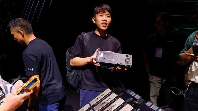 A man holds a processor signed by Nvidia Corp CEO Jensen Huang after his speech at the COMPUTEX forum in Taipei, Taiwan May 29, 2023