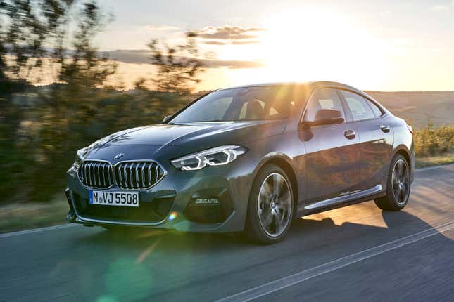 Front 3/4 of a BMW 2 series gran coupe driving in front of a sunset