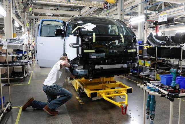 A production employee works on a Canoo at a factory in Michigan