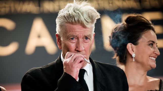 David Lynch seen smoking a cigarette at an award show. 