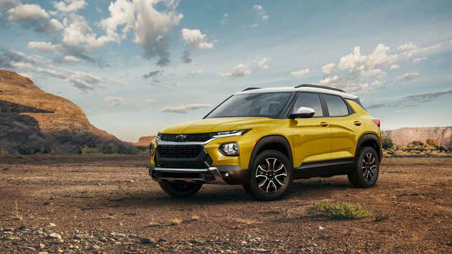 A photo of a yellow Chevrolet Trailblazer parked in the desert. 