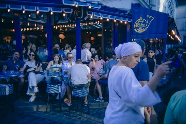 People sit at a restaurant in July 2024 in Paris, France.