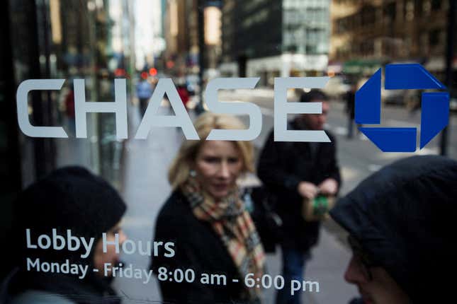 A woman is walking out the door of a JPMorgan Chase location