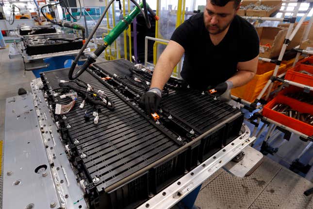 A Renault employee works on the batteries of the the Zoe electric car, on the assembly line of the Renault plant in Flins, west of Paris, France, Wednesday, April 20, 2016. The mining of minerals critical to electric vehicle batteries and other green technologies in Congo has led to human rights abuses, including forced evictions and physical assault. That&#39;s according to a report Tuesday from Amnesty International and another rights group. (AP Photo/Francois Mori)