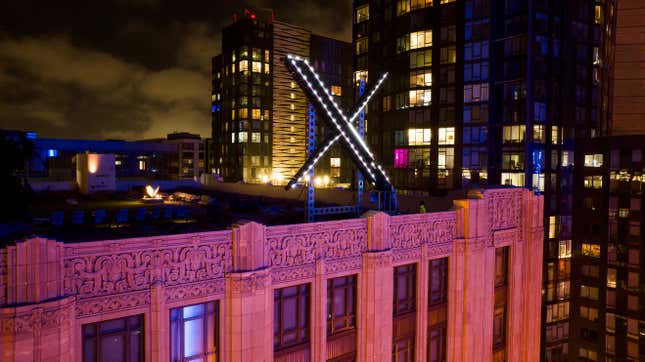 File - Workers install lighting on an &quot;X&quot; sign atop the company headquarters, formerly known as Twitter, in San Francisco, on July 28, 2023. The social media platform X says it is trying to take action on a flood of posts sharing graphic media, violent speech and hateful conduct about the latest war between Israel and Hamas. (AP Photo/Noah Berger, File)