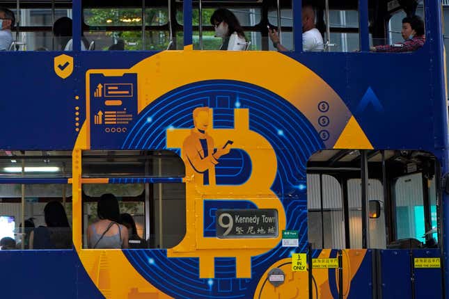 FILE - An advertisement for the cryptocurrency Bitcoin displayed on a tram, May 12, 2021, in Hong Kong. Now that bitcoin funds are trading, which is the best to own? The answer is not necessarily the one that rises the most. (AP Photo/Kin Cheung, File)