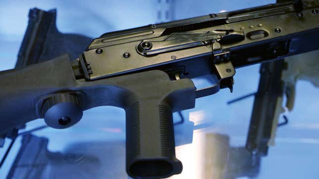 FILE - In this Oct. 4, 2017, file photo, a device called a &quot;bump stock&quot; is attached to a semi-automatic rifle at the Gun Vault store and shooting range in South Jordan, Utah. The Supreme Court has agreed to decide whether a ban on gun attachments that allow semi-automatic weapons to fire rapidly like machine guns violates federal law. The justices said Friday they&#39;ll hear arguments next year over a gun bump stocks regulation the Justice Department implemented after the 2017 Las Vegas mass shooting. (AP Photo/Rick Bowmer, File)