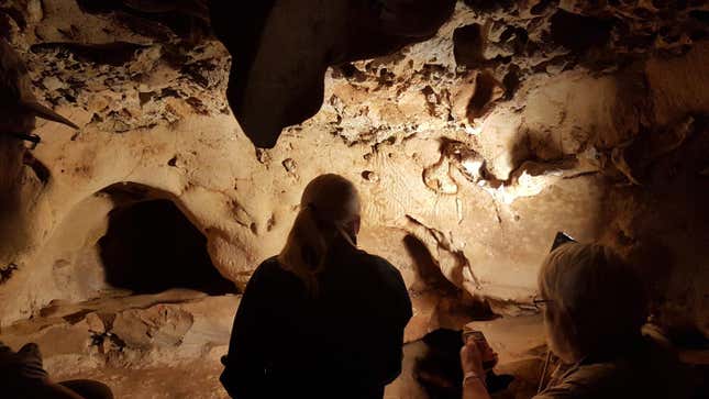 Researchers looking at finger marks (illuminated center) in La Roche Cotard.