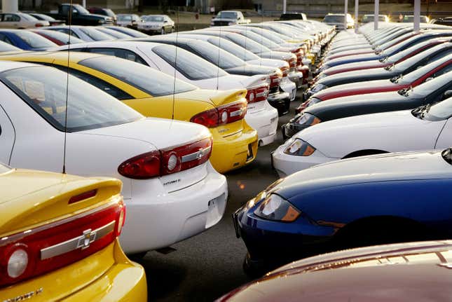 Cars sit on a dealership lot.