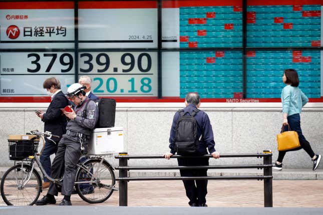 A person looks at an electronic stock board showing Japan&#39;s Nikkei 225 index at a securities firm Thursday, April 25, 2024, in Tokyo. (AP Photo/Eugene Hoshiko)