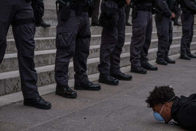 A protester holds a die-in in front of a row of police officers during a peaceful protest over the death of George Floyd at the State Capital building in downtown Columbus, Ohio, on June 1, 2020.