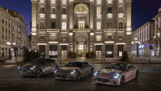 A photo of three electric Maserati cars parked in front of a historic building. 
