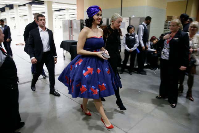 Singer Katy Perry, wearing a dress with Democratic presidential candidate Hillary Rodham Clinton's campaign logo, arrives at the Iowa Democratic Party's Jefferson-Jackson Dinner, Saturday, Oct. 24, 2015, in Des Moines, Iowa. (AP Photo/Charlie Neibergall)