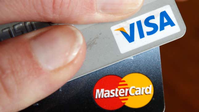 A credit card user displays her cards in Washington February 22, 2010. This logo has been updated and is no longer in use.