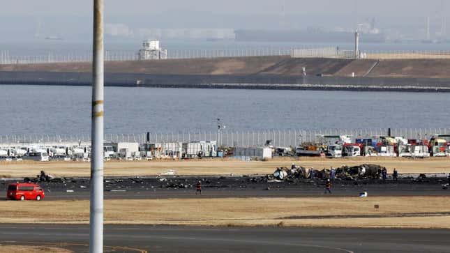 Officials investigate the wreckage of a De Havilland Canada Dash 8 aircraft operated by the Japan Coast Guard following a collision at Haneda Airport in Tokyo, Japan, on Wednesday, Jan 3, 2024.