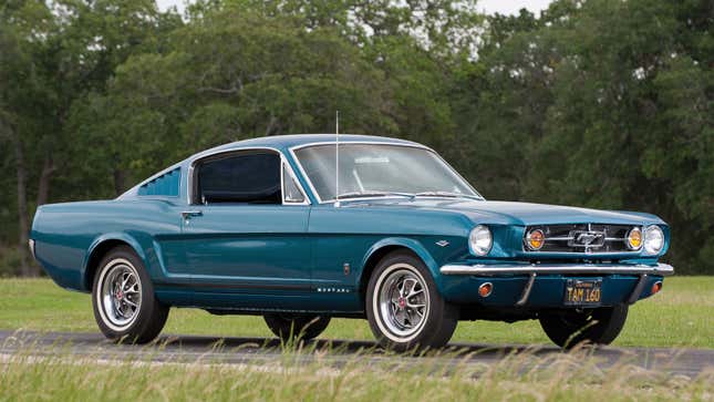 A photo of a teal Fastback Ford Mustang from the 1960s. 