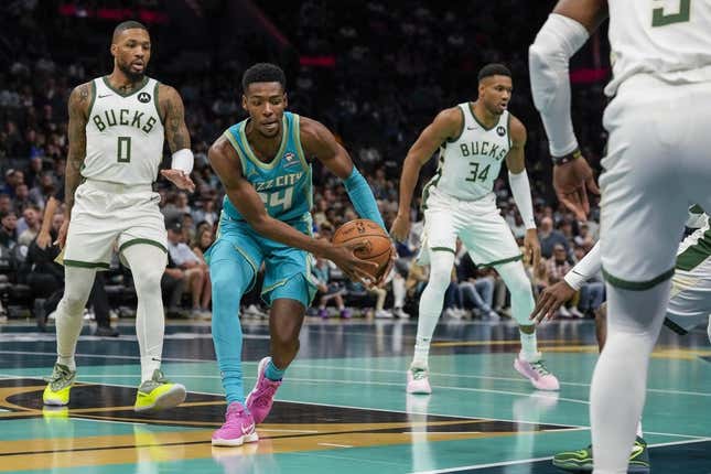 Nov 17, 2023; Charlotte, North Carolina, USA; Charlotte Hornets forward Brandon Miller (24) recovers the ball defended by Milwaukee Bucks guard Damian Lillard (0) during the first quarter at the Spectrum Center.