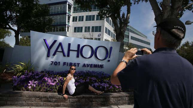 People take pictures in front of a sign that posted in outside of the Yahoo! headquarters on May 23, 2014 in Sunnyvale, California. 