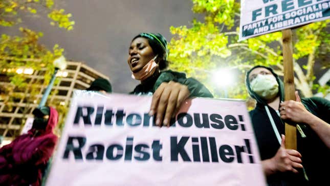 A protester holds a sign during a demonstration Friday, Nov. 19, 2021, in Oakland, Calif., following the acquittal of Kyle Rittenhouse in Kenosha, Wis. 