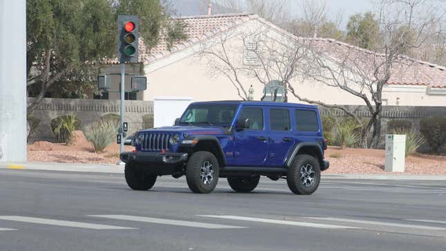 A dark blue Jeep Wrangler Rubicon JL turning onto North Jones Boulevard from Tropical Parkway in Las Vegas, Nevada.