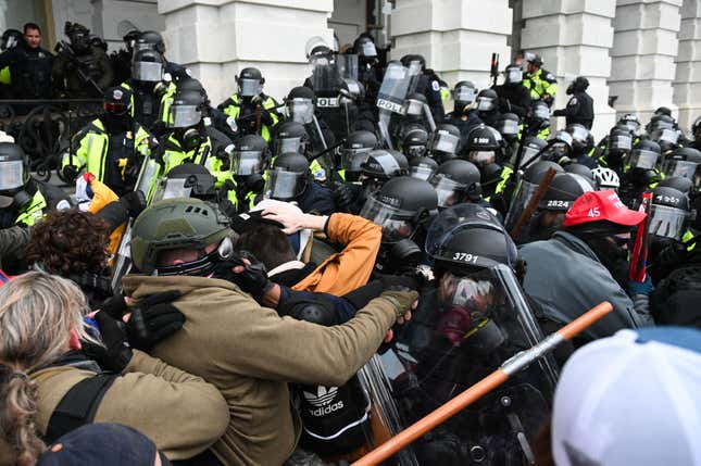 Riot police push back a crowd of supporters of US President Donald Trump after they stormed the Capitol building on January 6, 2021 in Washington, DC. 