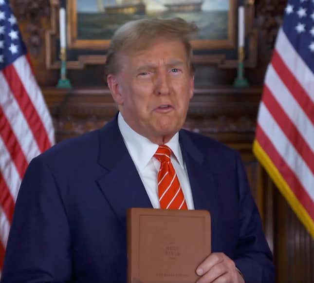 Former President Donald Trump holding Bible. 