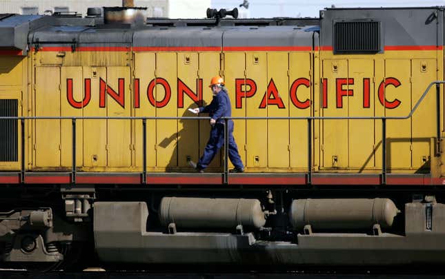 FILE - A maintenance worker walks past the company logo on the side of a locomotive in the Union Pacific Railroad fueling yard in north Denver, Oct. 18, 2006. Union Pacific dramatically reduced its use of temporary limits on some businesses&#39; shipments over the past year after its customers complained, but regulators said Wednesday, April 17, 2024, that the railroad must go further to be in line with the other major freight railroads that rarely use such embargoes. (AP Photo/David Zalubowski, File)