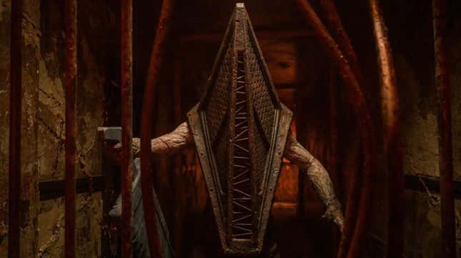 Pyramid Head holding a big sword behind bent bars