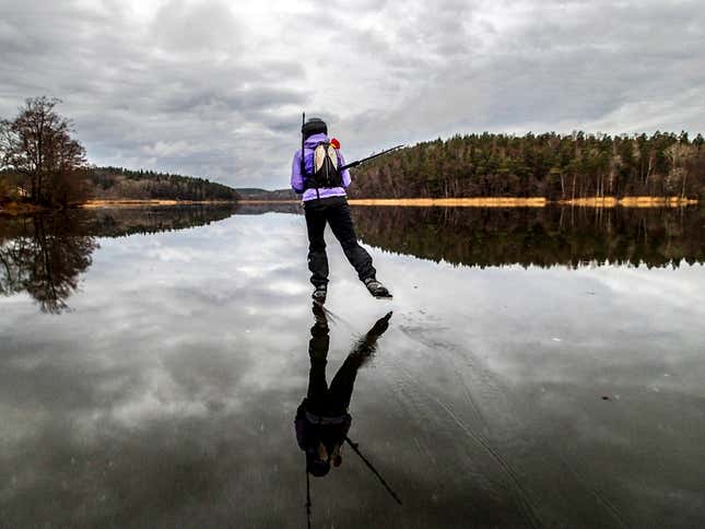A skater speeds on rain-wet ice on lake Orlangen, south of Stockholm, Sweden.