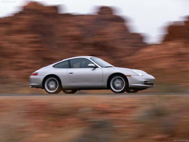 A silver 2003 Porsche Carrera drives in a canyon.