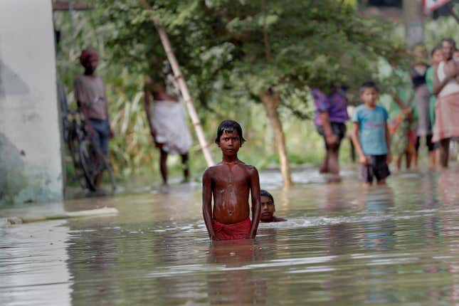 People wait to be rescued from a flooded village in Bihar.