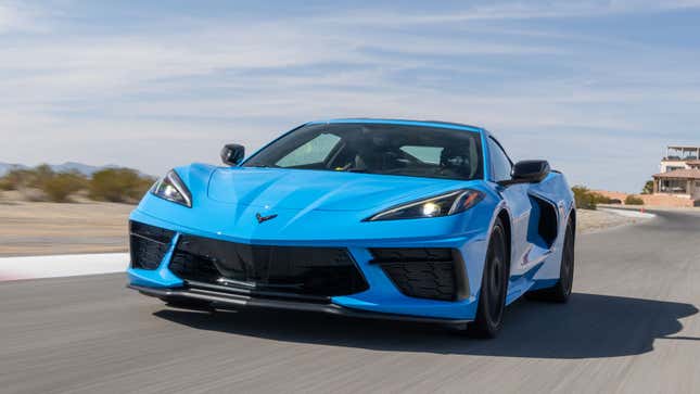 A photo of a blue C8 Corvette sports car on a road. 