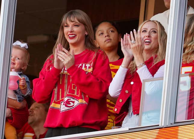 Taylor Swift watching football game wearing red Kansas City Chiefs merch