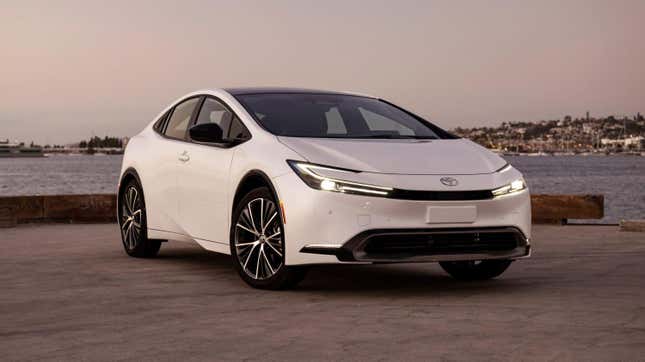 A white Toyota Prius on a quay