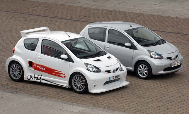 Toyota Aygo Crazy Concept parked next to a stock Aygo, front 3/4 view