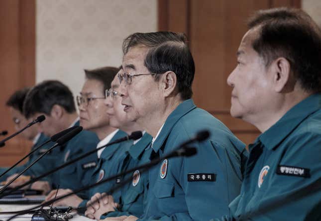 South Korean Prime Minister Han Duck-soo, second from right, presides over a meeting of ministers at the government complex in Seoul, South Korea, Monday, Feb. 19, 2024. Trainee doctors in South Korea began resigning en masse Monday in protest of a government medical policy, causing reported delays in surgeries and other treatments at hospitals though no major disruption in the country&#39;s medical service has yet occurred.(Hwang Gang-mo/Yonhap via AP)