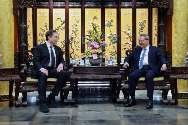 In this photo released by Xinhua News Agency, visiting Tesla founder and CEO Elon Musk, left, meets with Chinese Premier Li Qiang in Beijing, Sunday, April 28, 2024. Musk met with a top government leader in the Chinese capital Sunday, just as the nation&#39;s carmakers are showing off their latest electric vehicle models at the Beijing auto show. (Wang Ye/Xinhua via AP)