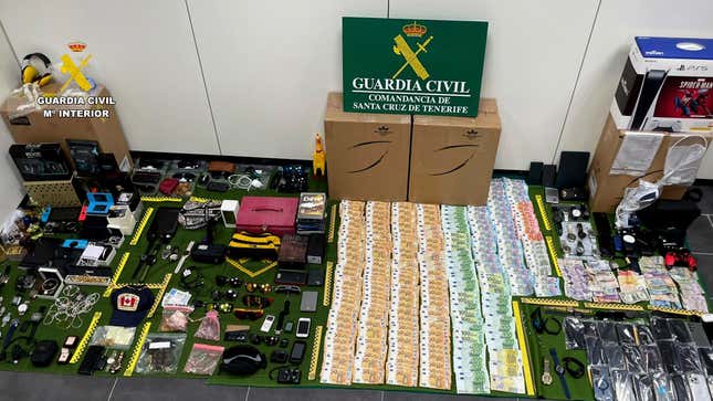 In this photo provided by the Guardia Civil on Friday Dec. 15, 2023, items stolen from suitcases are displayed on the Canary island of Tenerife, Spain. Spanish police say they have arrested 14 workers at one of the country&#39;s main tourist airports on suspicion of stealing items from checked-in luggage. Police seized allegedly stolen items worth almost 2 million euros ($2.2 million) from the group of employees at the largest airport in Tenerife, in Spain&#39;s Canary Islands. (Guardia Civil via AP)