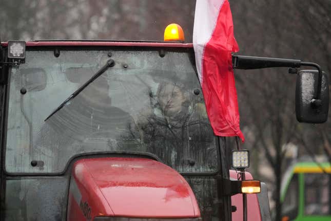 Farmers driving in a heavy-duty tractor into the western city of Poznan as part of a nationwide farmer protest against European Union&#39;s agrarian policy and imports of cheap Ukraine produce, which, they say, are undercutting their livelihoods, in Poznan, Poland, on Friday Feb. 9, 2024. (AP Photo/Czarek Sokolowski)