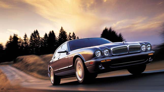 A Jaguar XJ drives at sunset. 