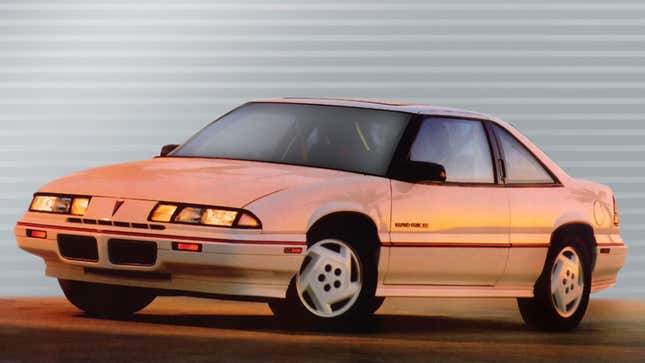 A photo of a white Pontiac Grand Prix coupe from the 1990s. 