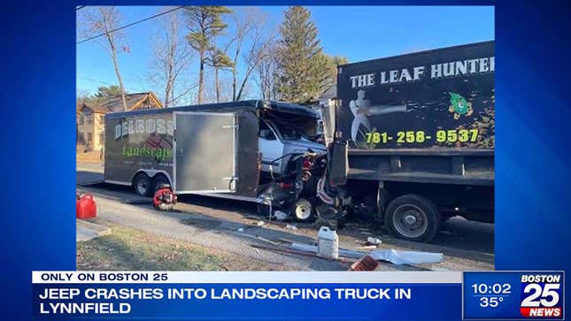 A photo of a jeep crashed into the back of a box trailer. 