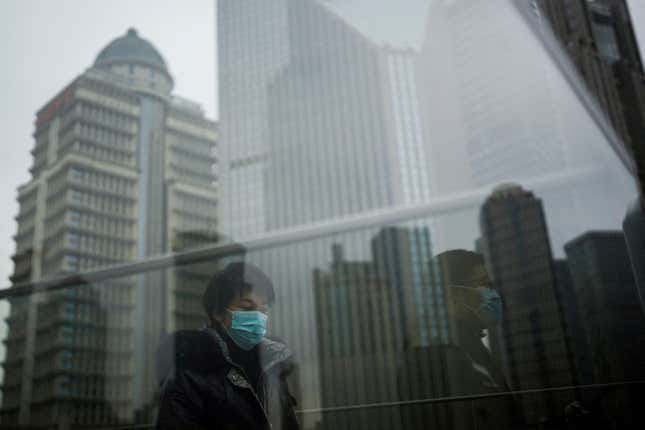 People wearing surgical masks in Shanghai, December 2022.