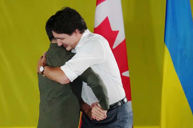 Prime Minister Justin Trudeau, right, embraces Ukrainian President Volodymyr Zelenskyy as he is introduced during a rally at the Fort York Armoury in Toronto on Friday, Sept. 22, 2023. (Chris Young/The Canadian Press via AP)