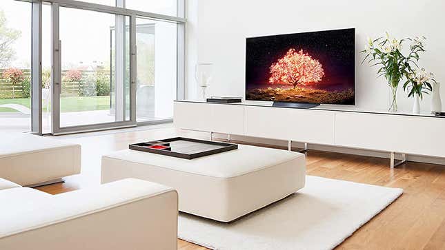 An LG OLED B1 sits on an all white media cabinet.