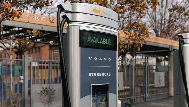 A Volvo electric vehicle charger sits outside of a Starbucks location.