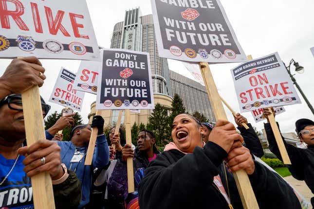 Prep cook Lakishia Williams, right, joins hundreds of unionized workers to walk the picket line during a strike in front of the MGM Grand Detroit casino, in Detroit, Tuesday, Oct. 17, 2023. (David Guralnick/Detroit News via AP)